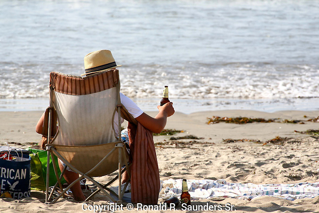 MAN-RELAXES-WHILE-ENJOYING-BEER-at-the-BEACH.jpg