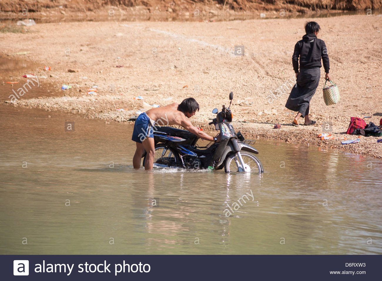 man-washing-motorcycle-in-inle-lake-indein-village-near-taunggyi-shan-D6RXW3.jpg