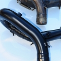 Ceramic coated rear header alongside non-coated header.
