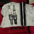 Difference in spark plug body above the threads.
